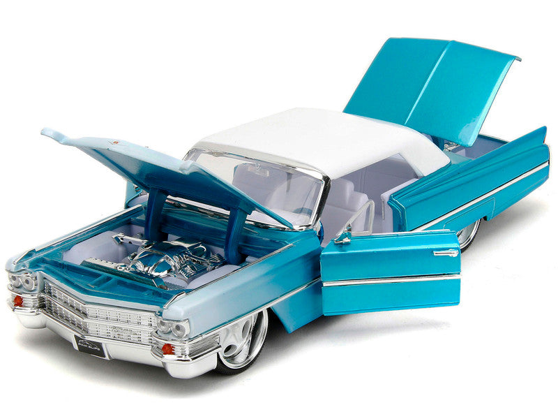 1963 Cadillac Coupe DeVille Blue Metallic and White Gradient with White Top and Interior "Pink Slips" Series 1/24 Diecast Model Car by Jada